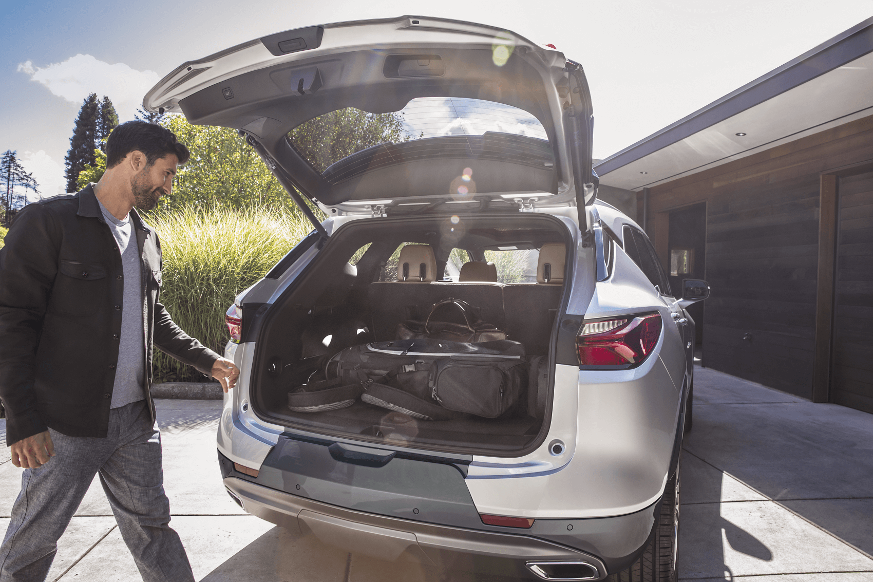 the open tailgate of a silver chevy blazer shows the blazer's cargo space volume